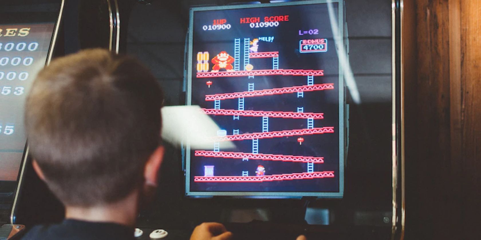 A child plays Donkey Kong, a classic arcade game with different levels