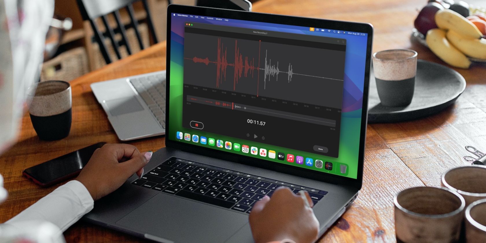 person recording a voice memo on a MacBook Pro