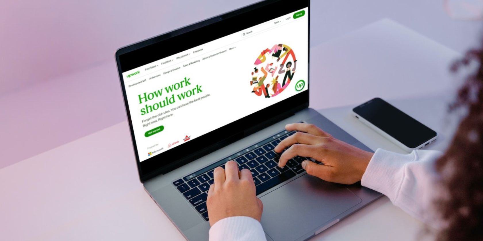 Person working with laptop showing Upwork homepage