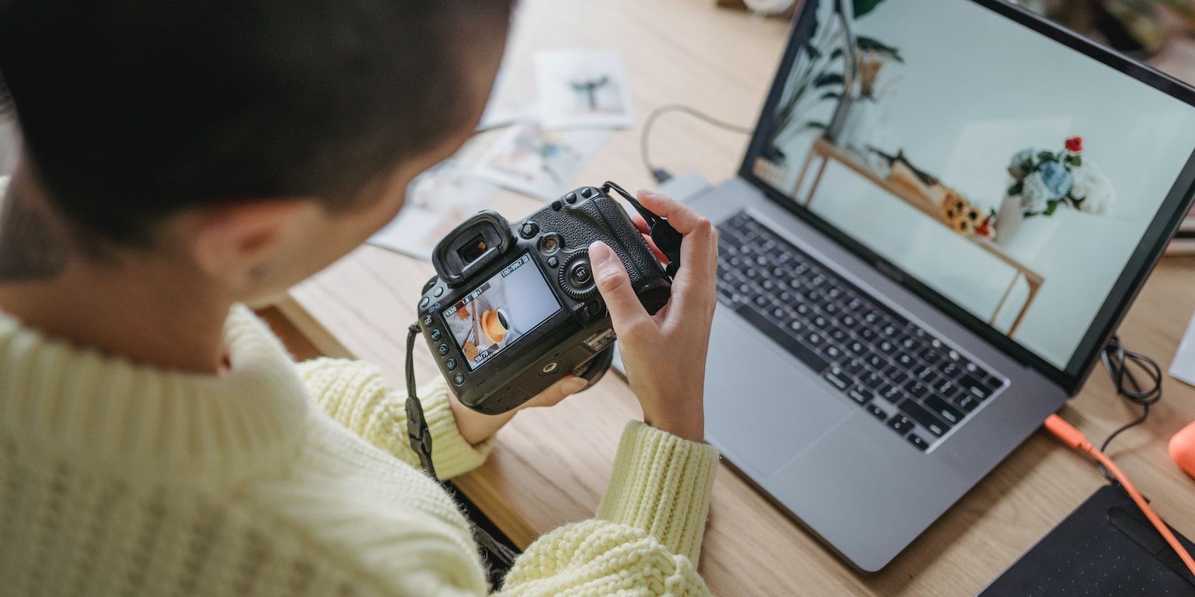 Photographer Viewing Photos on Camera and Laptop