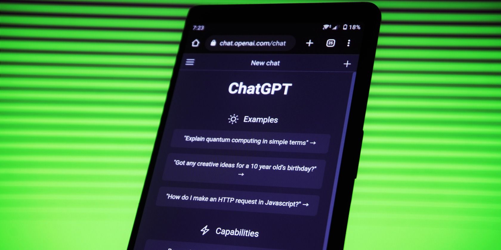 A phone against a green background with ChatGPT open on the screen.