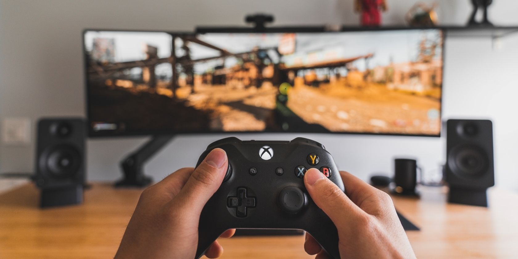 A photograph of an Xbox Wireless Controller in front of a gaming monitor