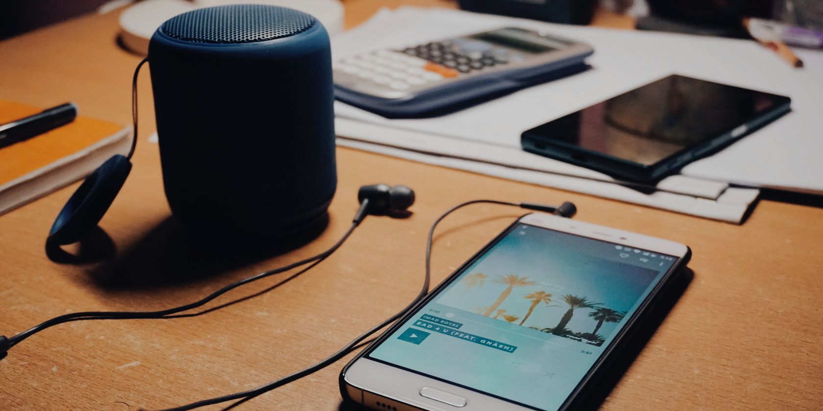 Samsung Phone and Bluetooth Speaker on a desk