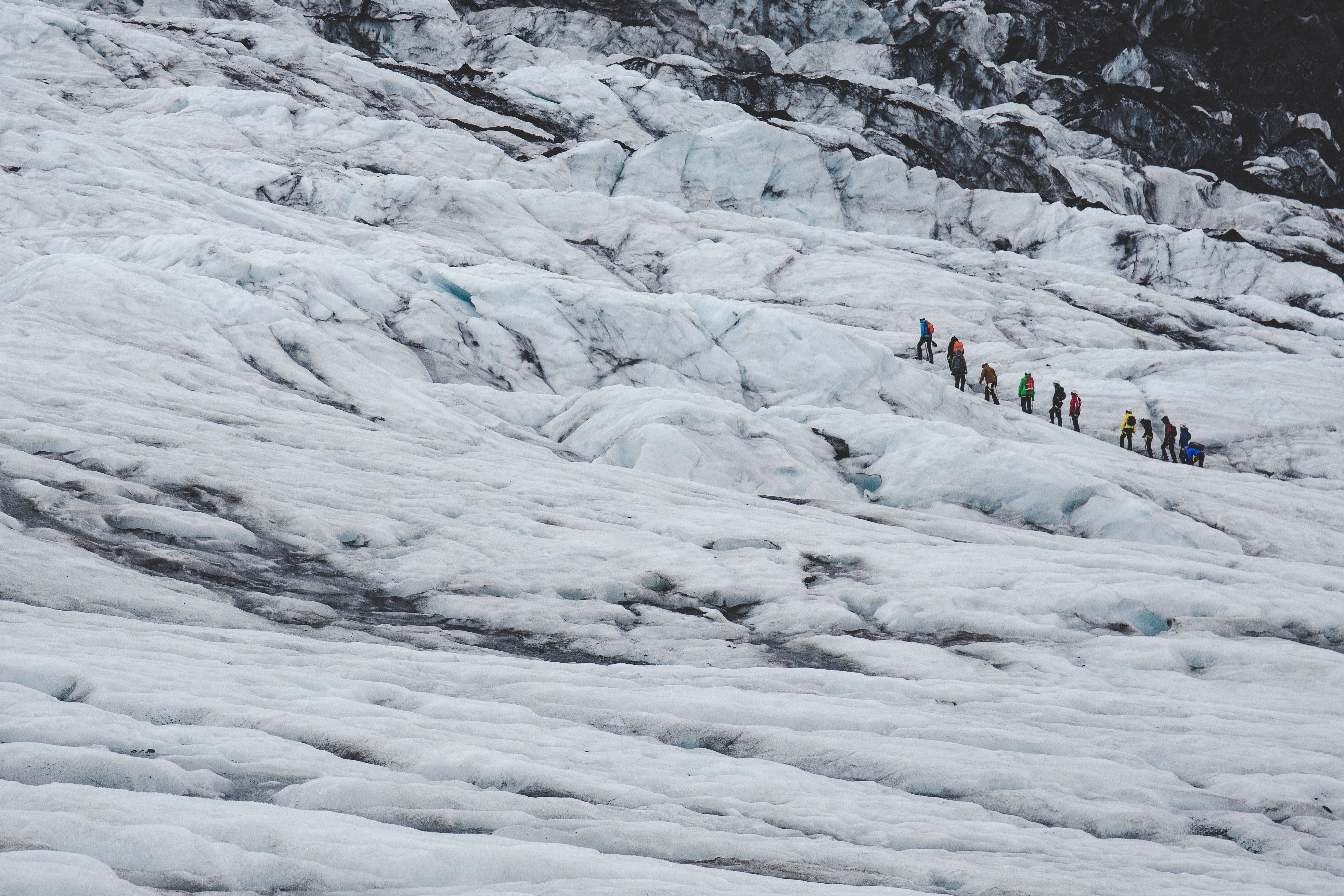 Photo of People Hiking Across a Glacier