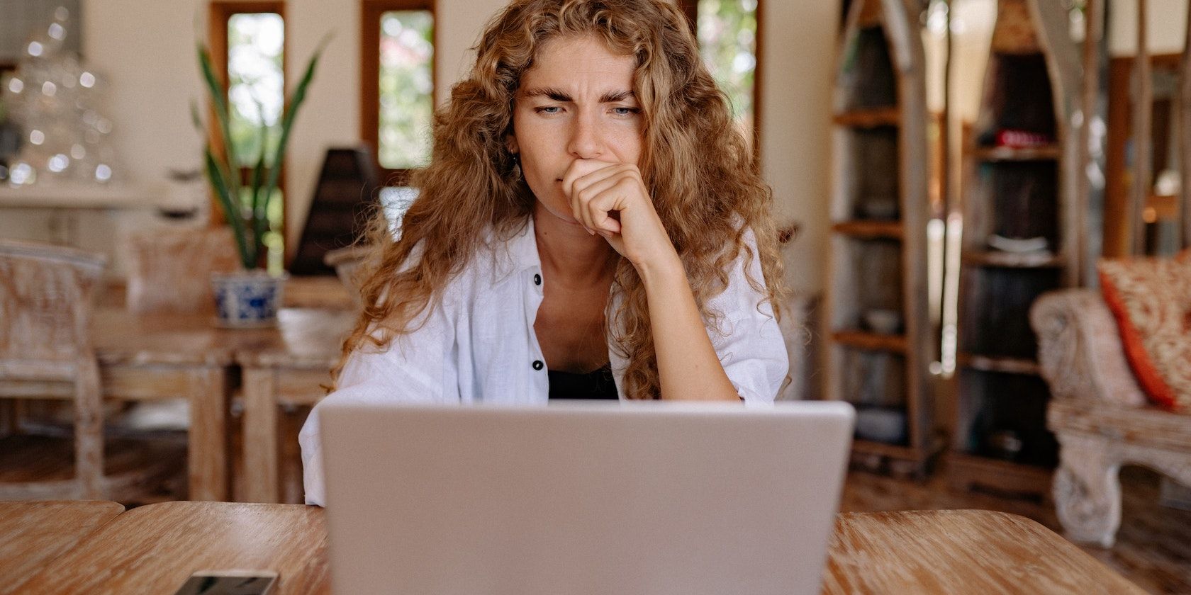 Woman staring seriously at her laptop