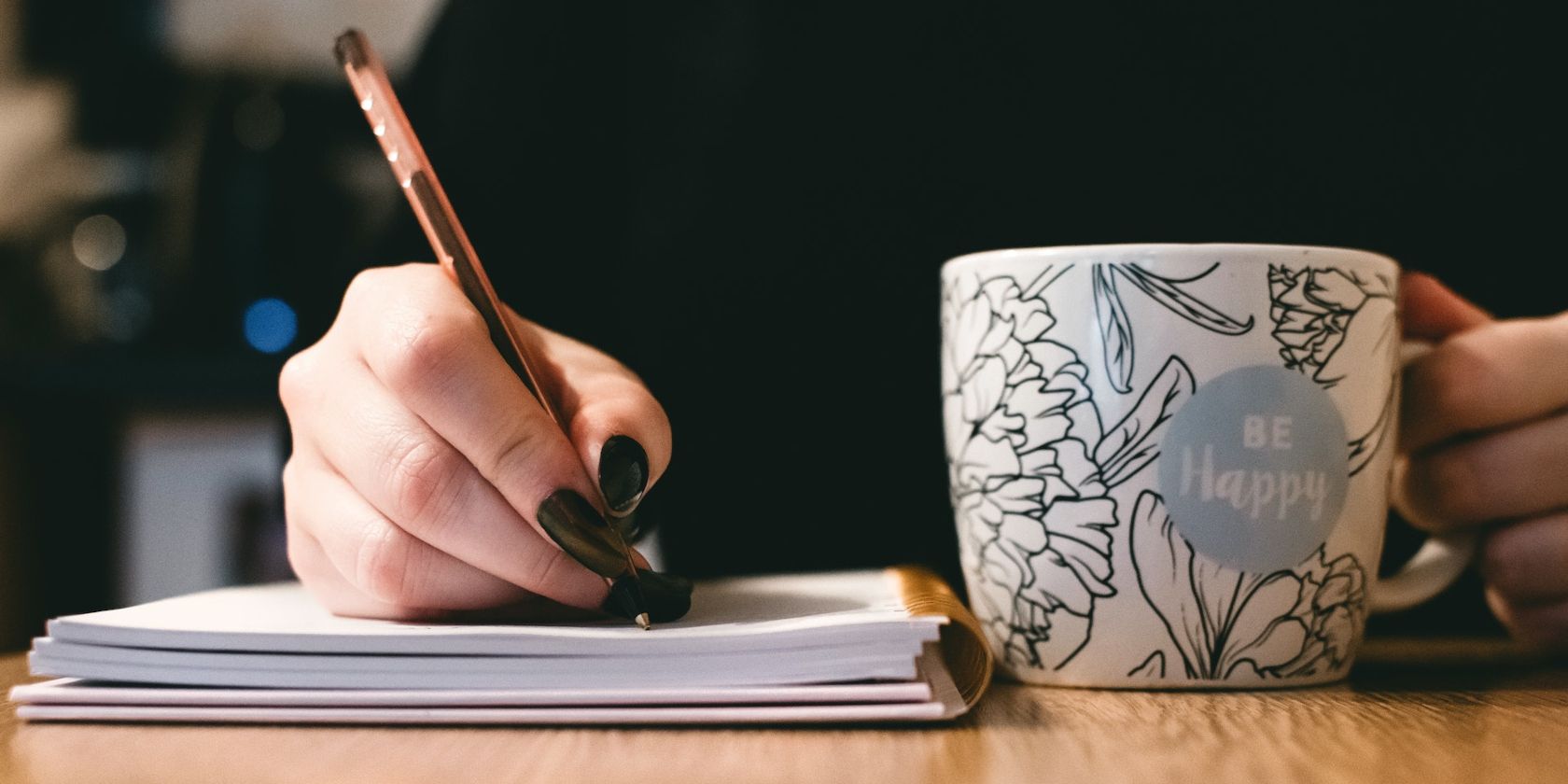 Writer Using a Notebook and Mug