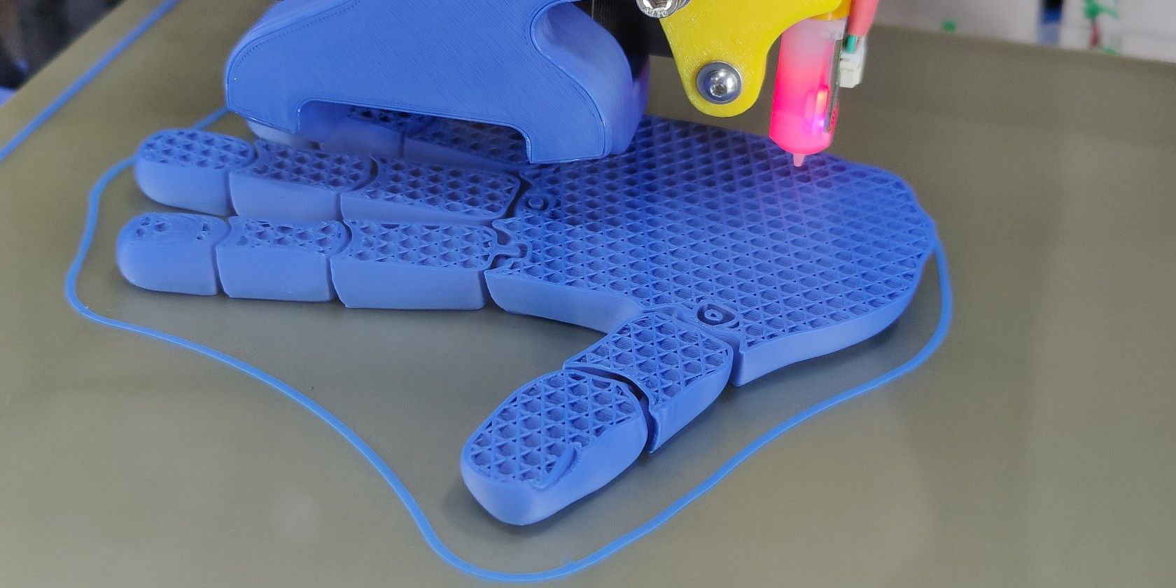 An FDM 3D printer in the middle of printing an ABS 3D print of an articulated human hand