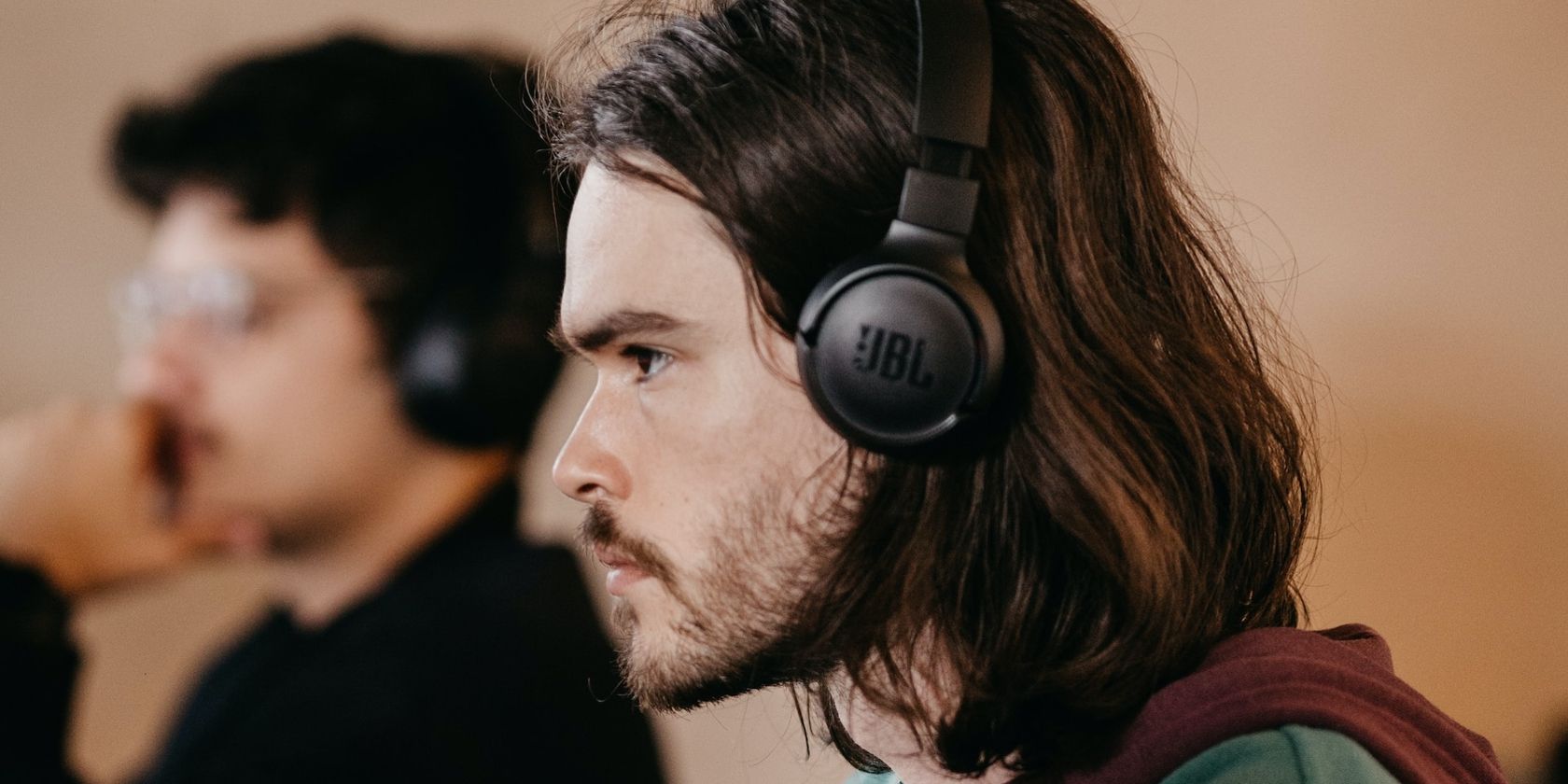 a person wearing headphones beside another person wearing headphones