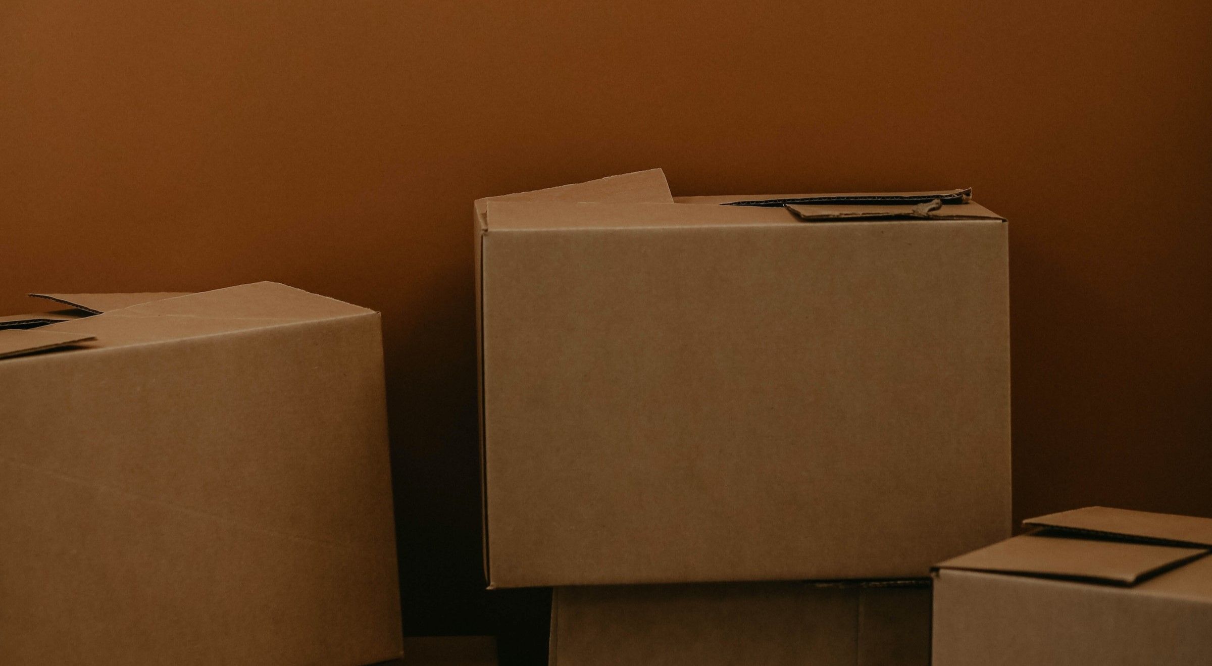 pile of cardboard boxes on brown background