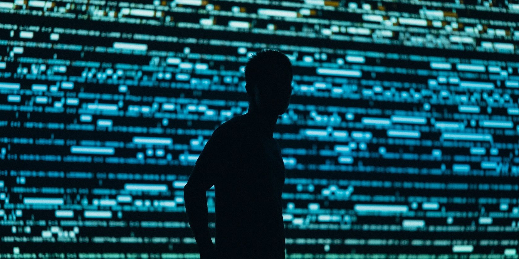 silhouette photography of man in front of a screen