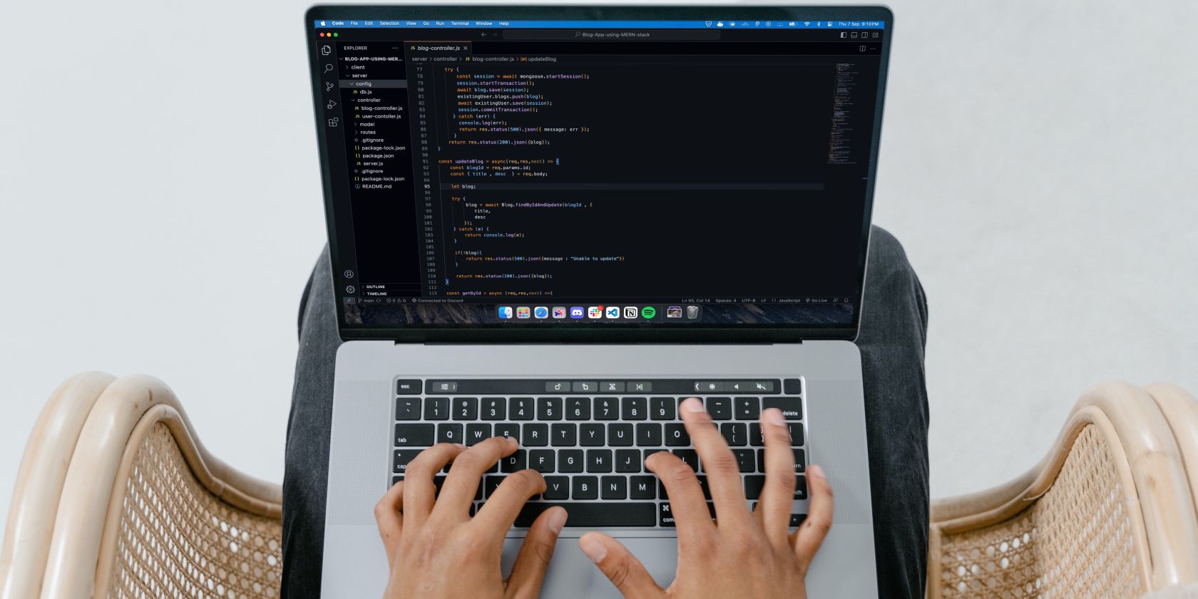 Person Coding on a MacBook using Visual Studio Code