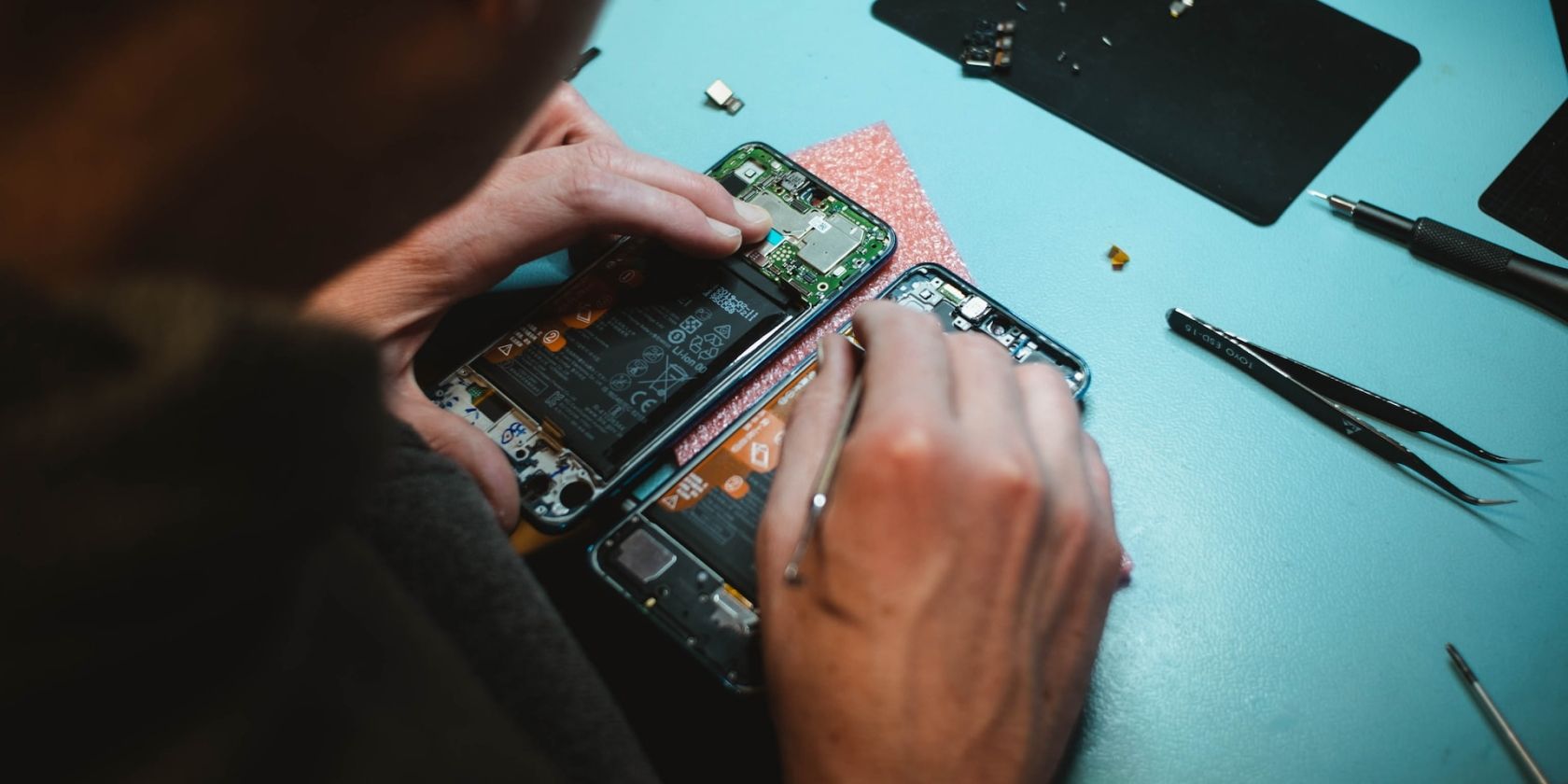 person replacing iPhone battery