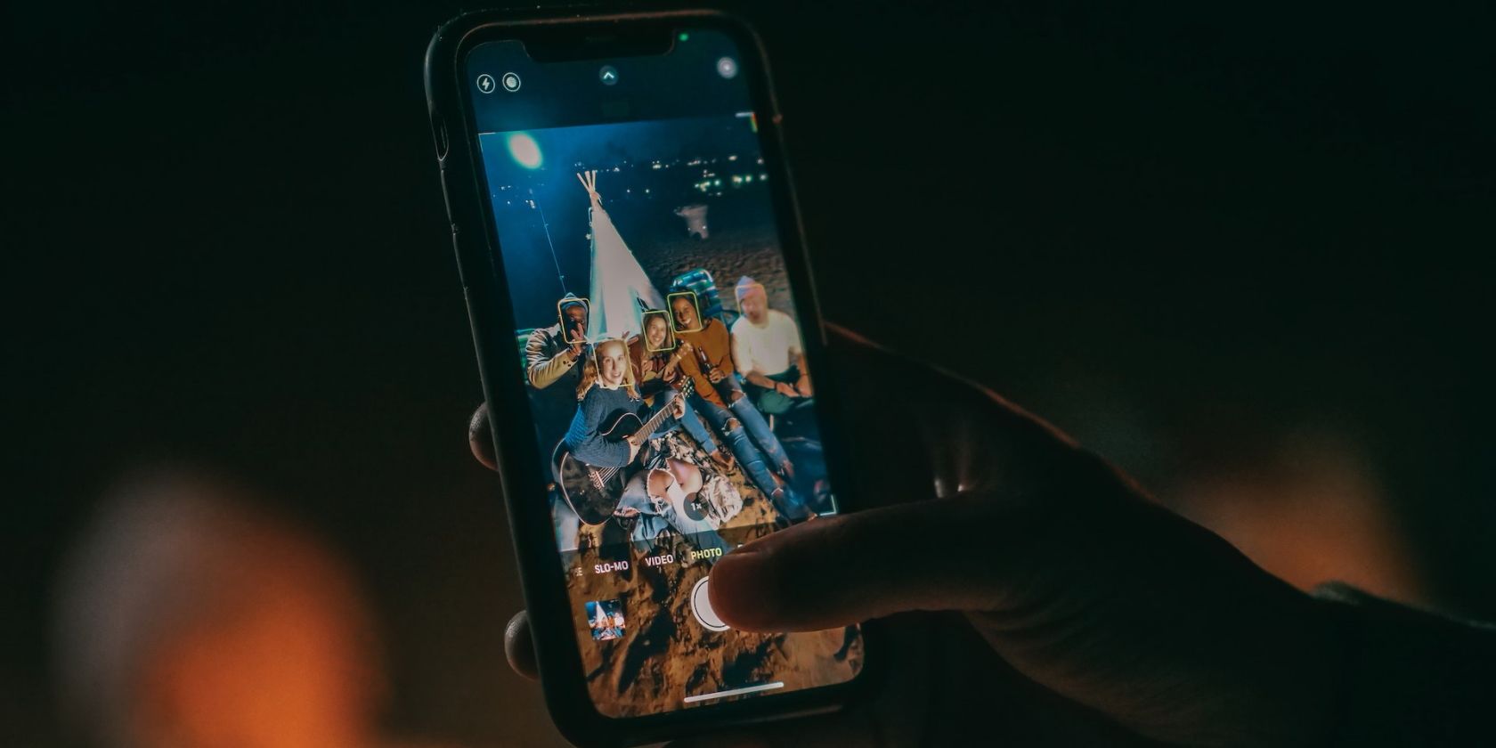 person taking a group photo on an iPhone