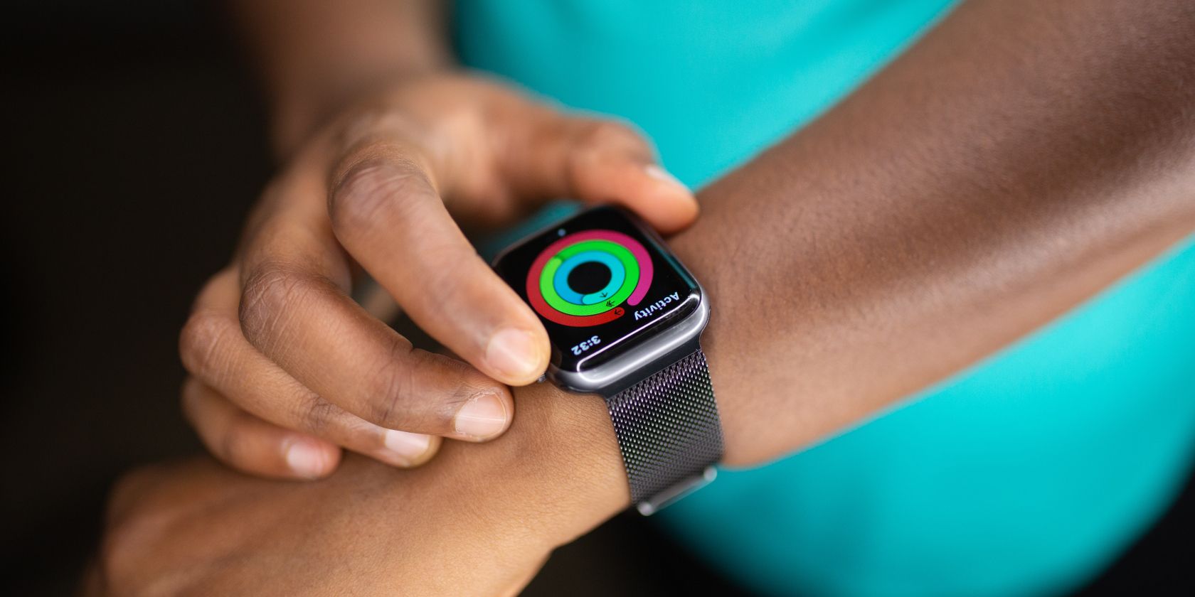 person wearing an apple watch while pressing its button