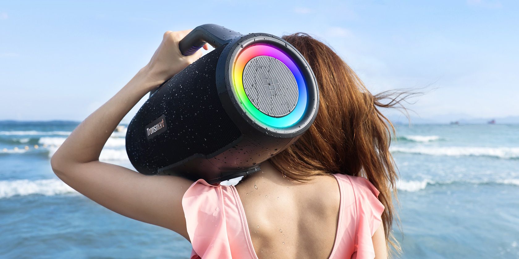 tronsmart bang max speaker on woman's shoulder at the beach