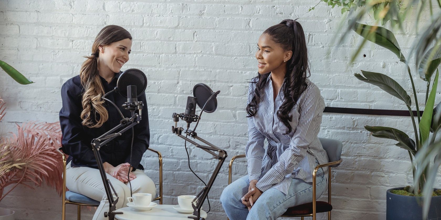Two women on a podcast set