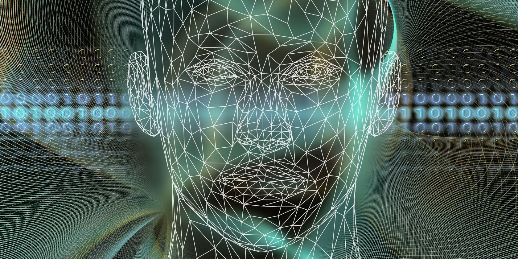A wireframe illustration of a human head with binary numbers in the background