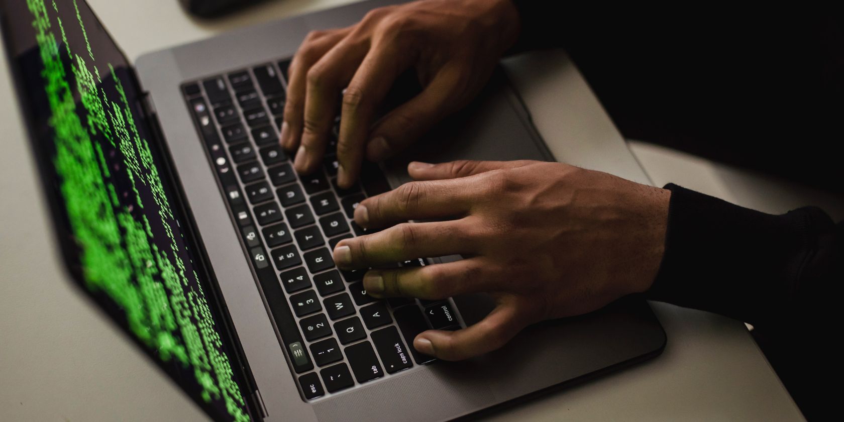 A man typing on laptop