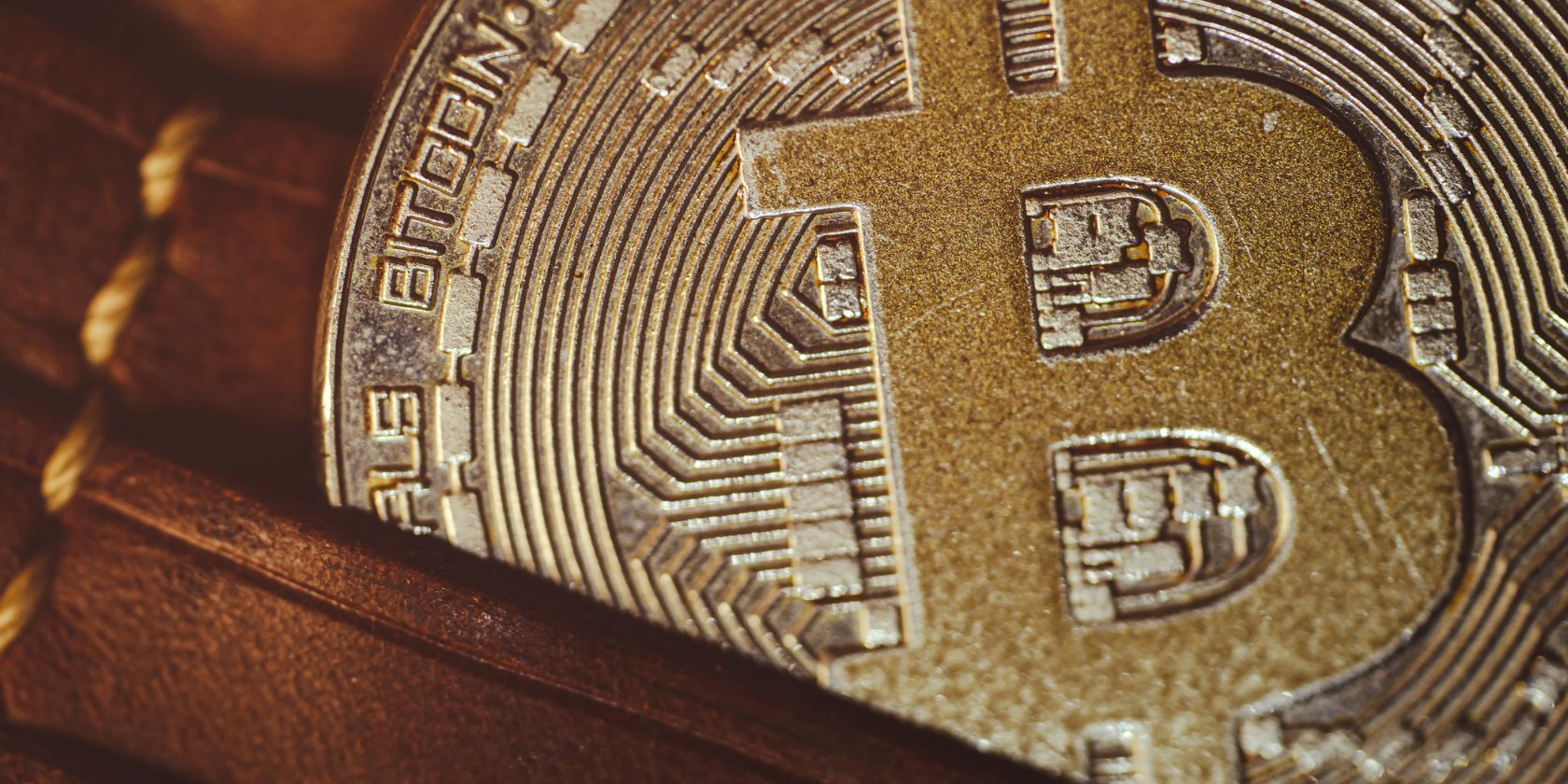 close up shot of bitcoin crypto coin in brown leather wallet
