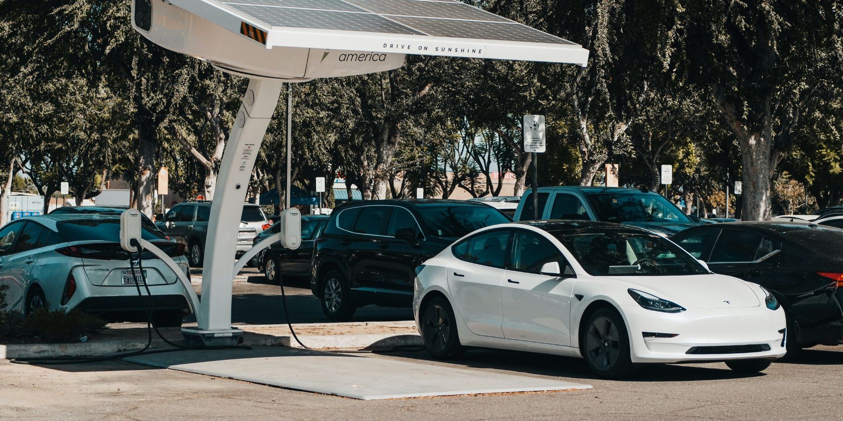 electric cars charging in parking lot using solar charger