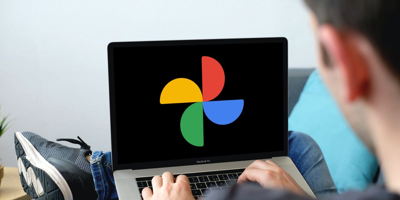 Person working on a laptop with Google Photos logo on screen. 