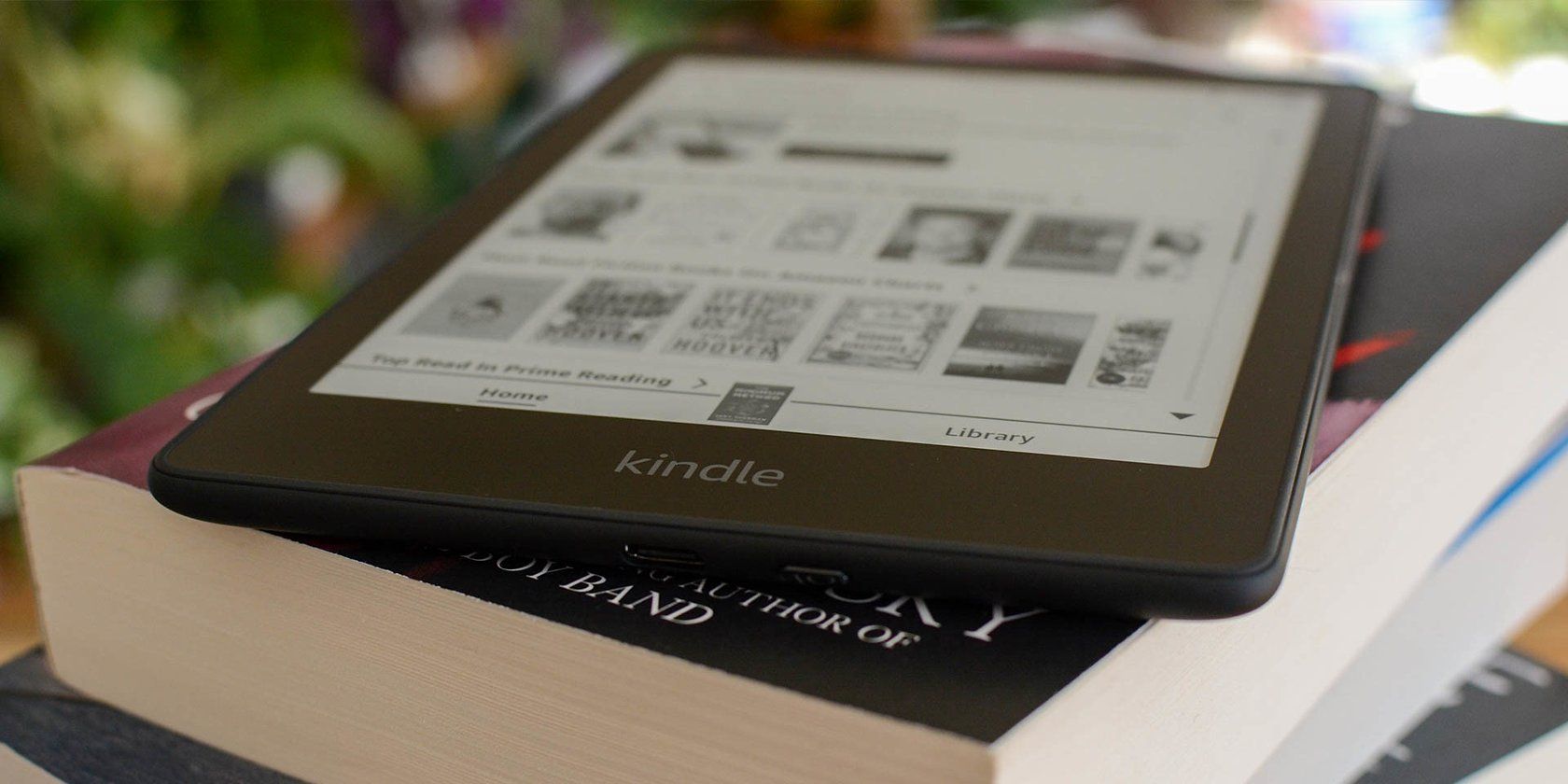 Kindle Paperwhite Signature Edition on a stack of books