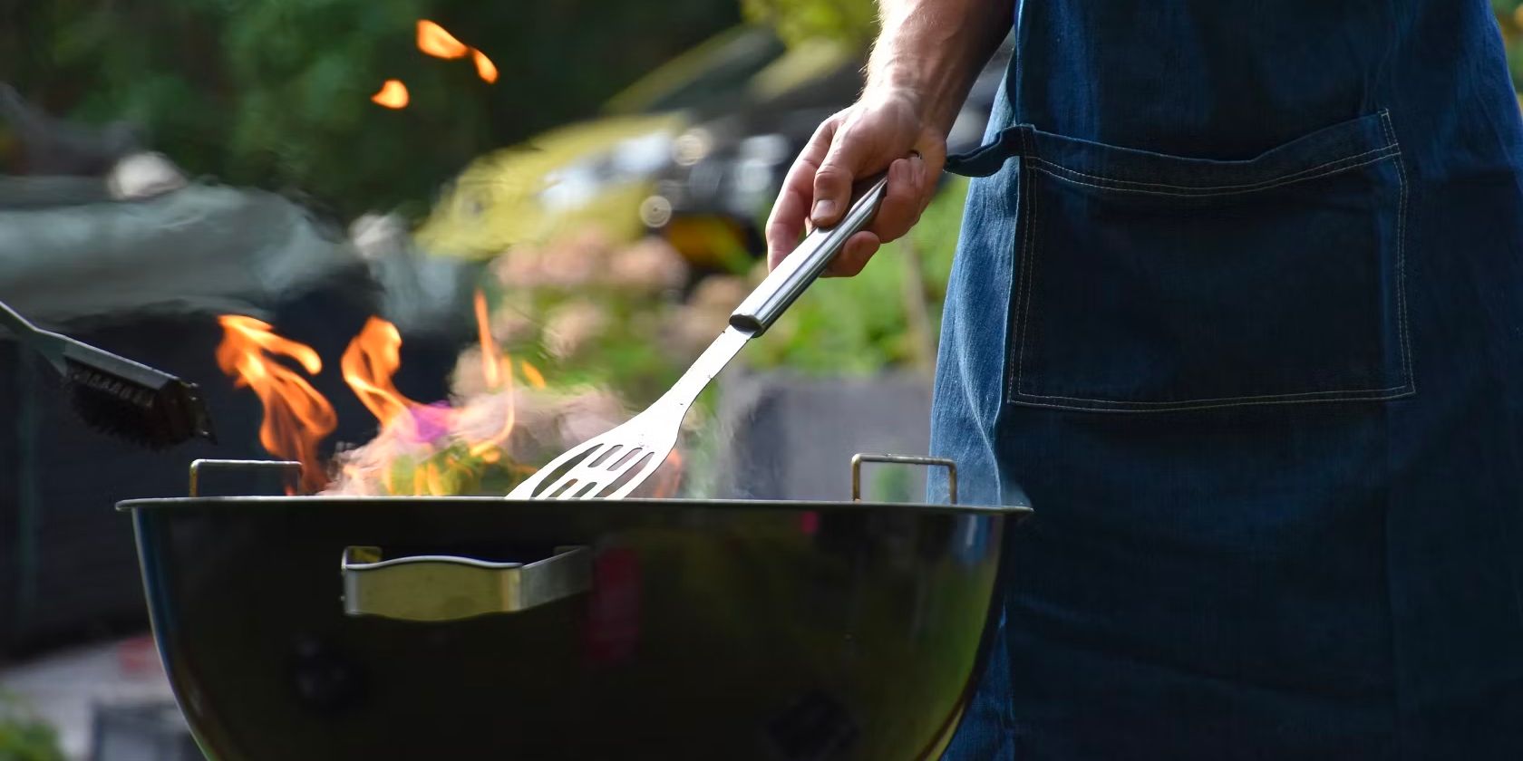 Man using tongs on barbecue