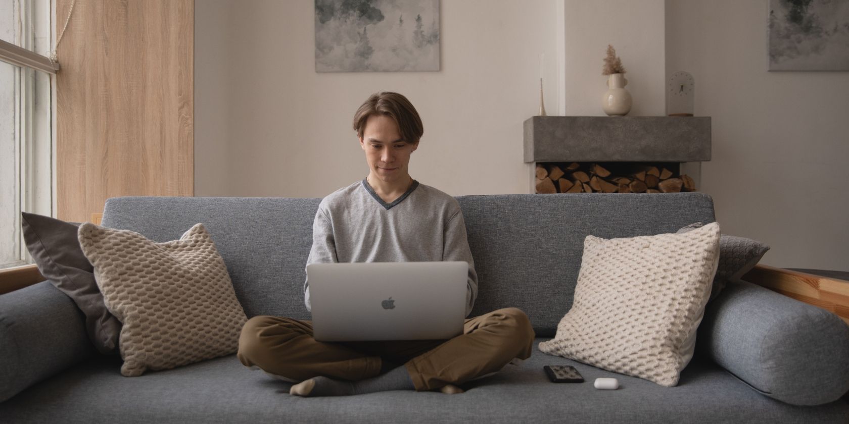man working on laptop on the couch