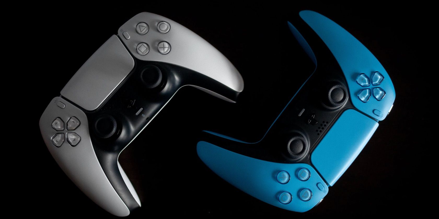 A White and Blue DualSense Controller on Black Background