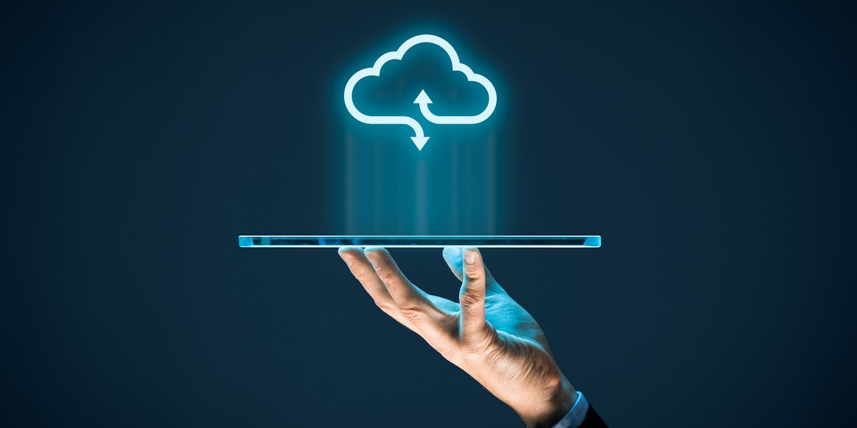 cloud storage concept person's hand holding tablet with cloud sign above
