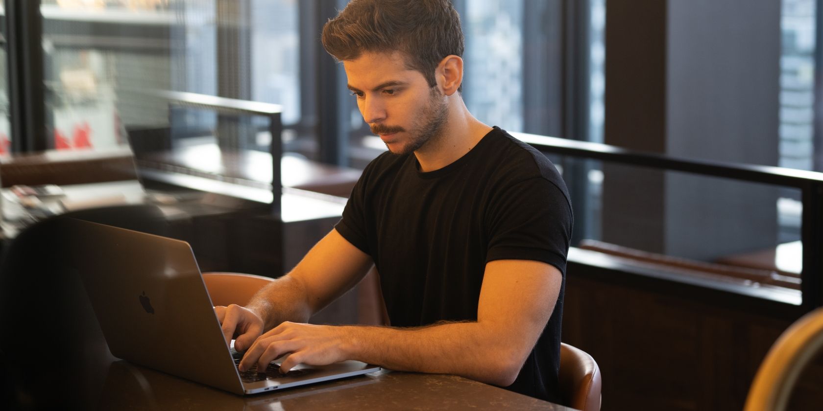 Man Using Laptop in Office Setting