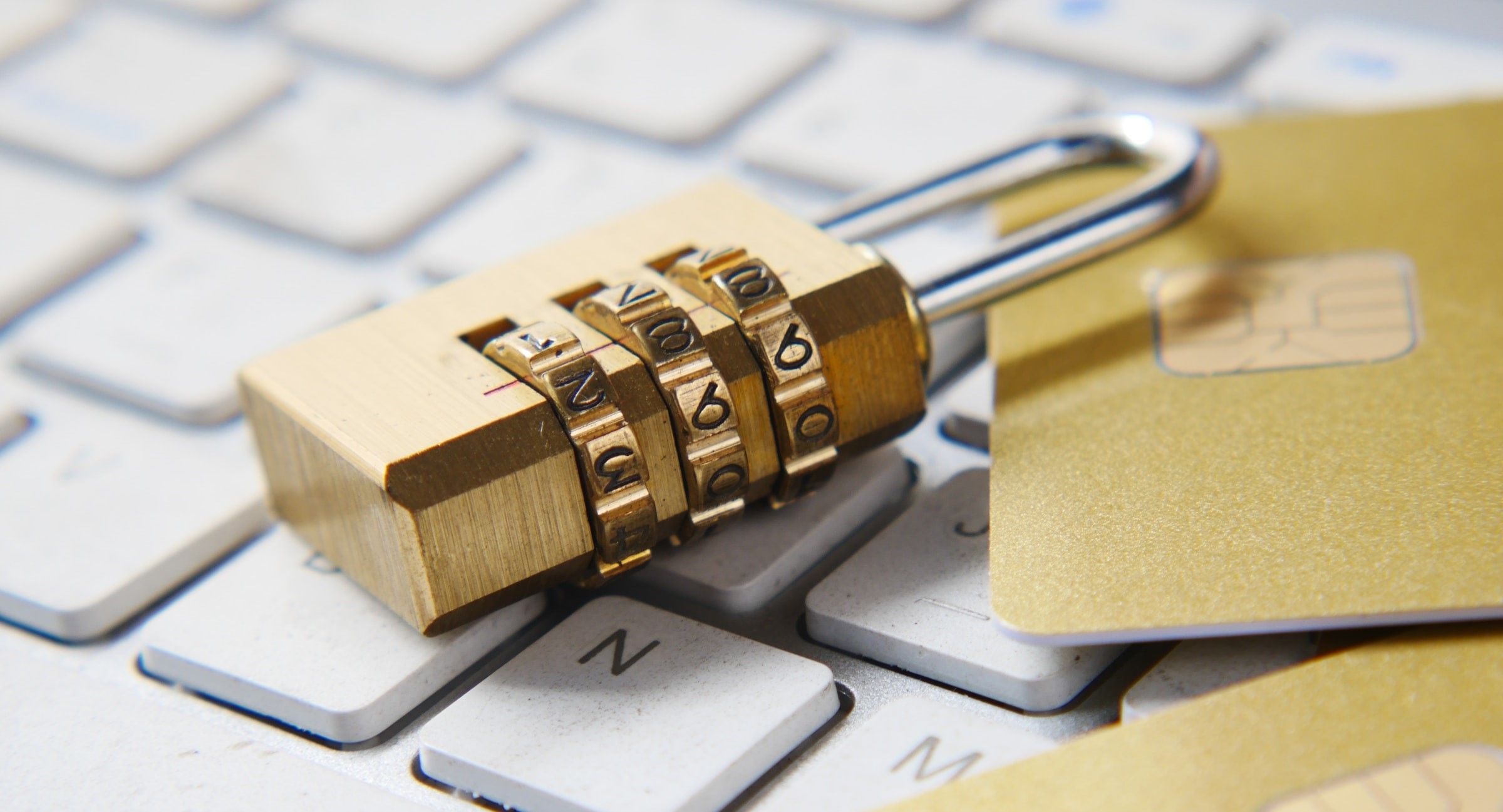 padlock on keyboard next to payment cards