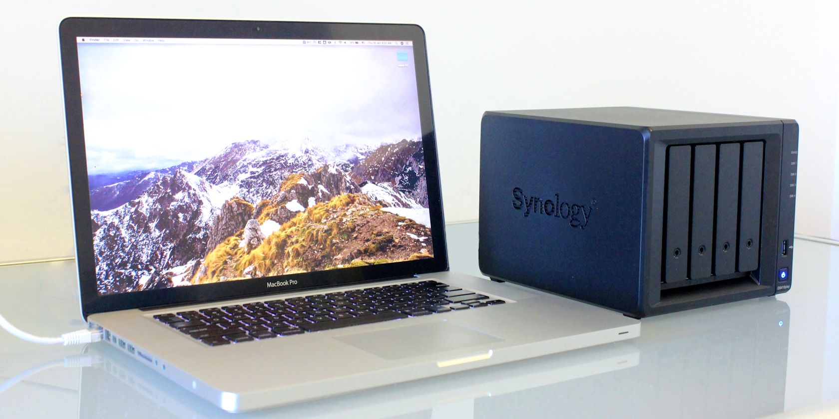macbook pro on table with synology nas