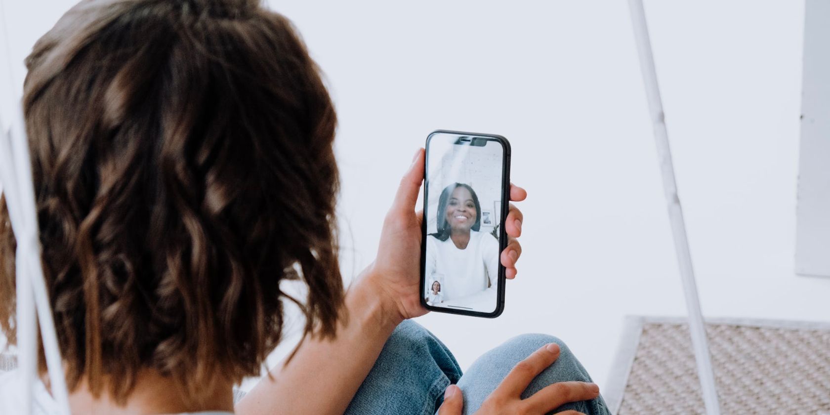 person holding iphone and engaged in video call