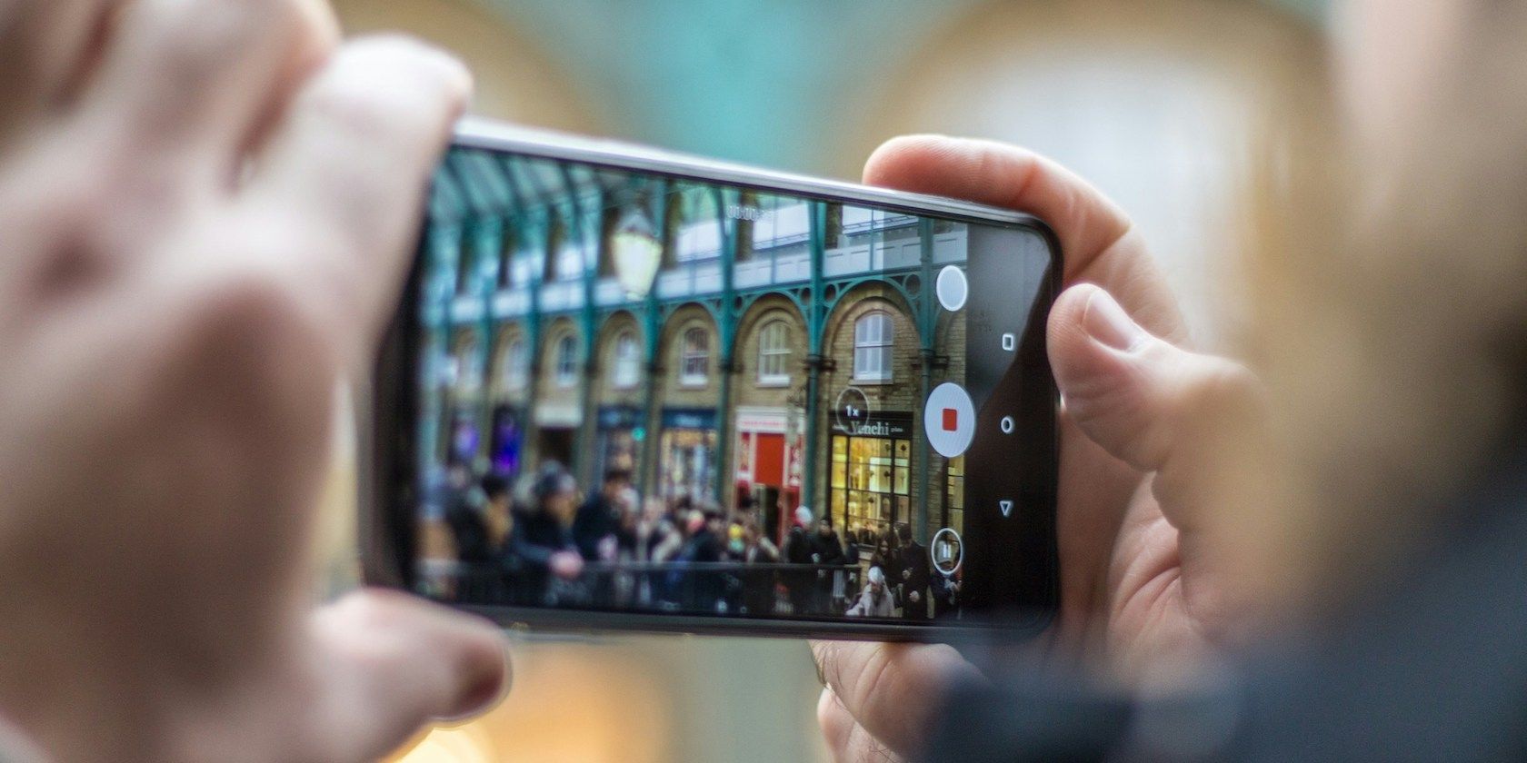 Hands holding a smartphone shooting a video