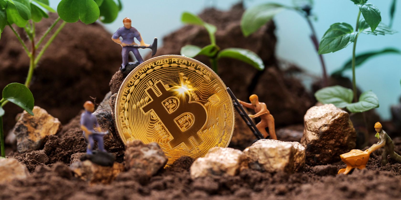 small figures mining a bitcoin in the garden