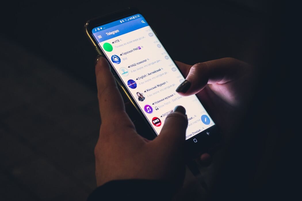 A user using the Telegram application on her Android device