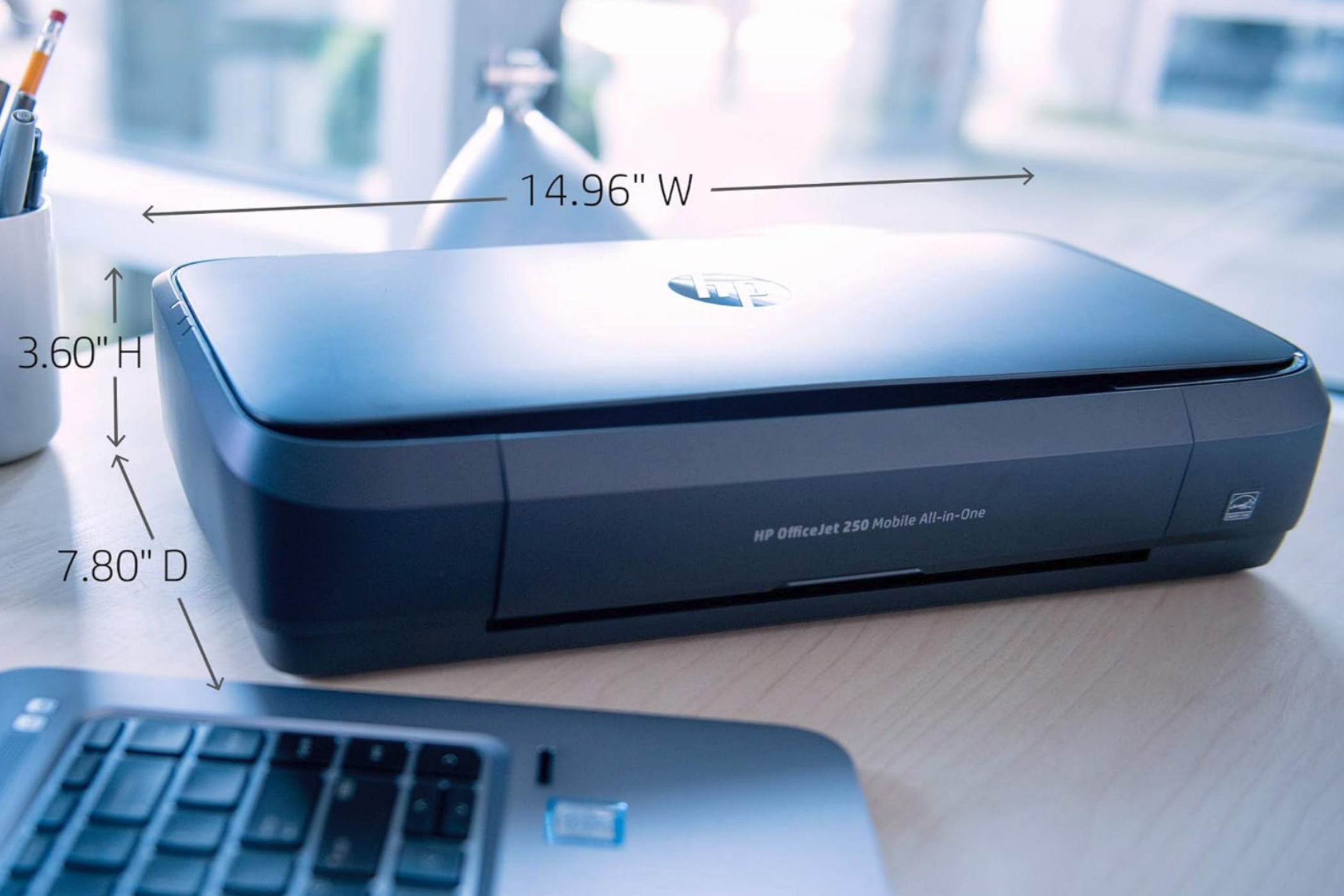 An HP OfficeJet 250 next to a laptop with compact dimensions displayed.