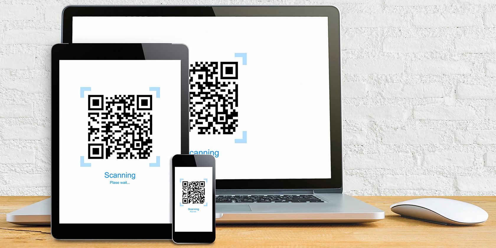 Laptop, tablet, and phone with QR codes showing