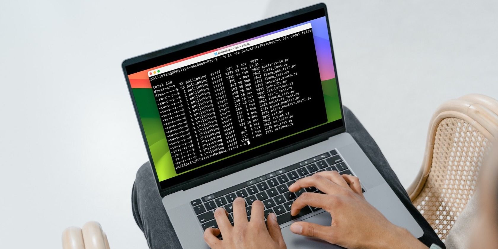 Man using MacBook with Terminal window on screen