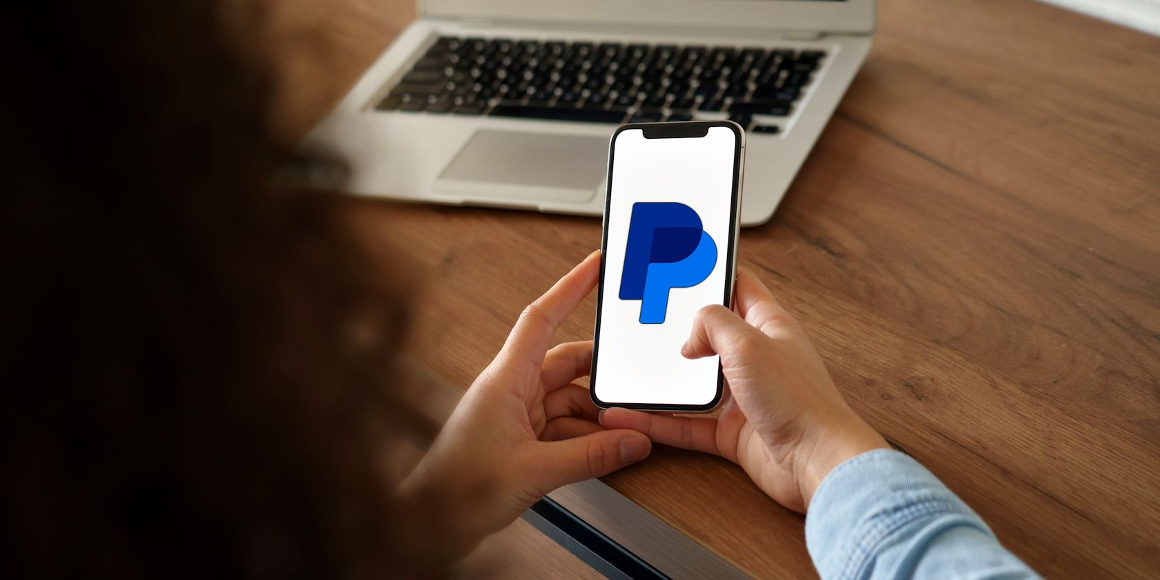 person using smartphone to access paypal
