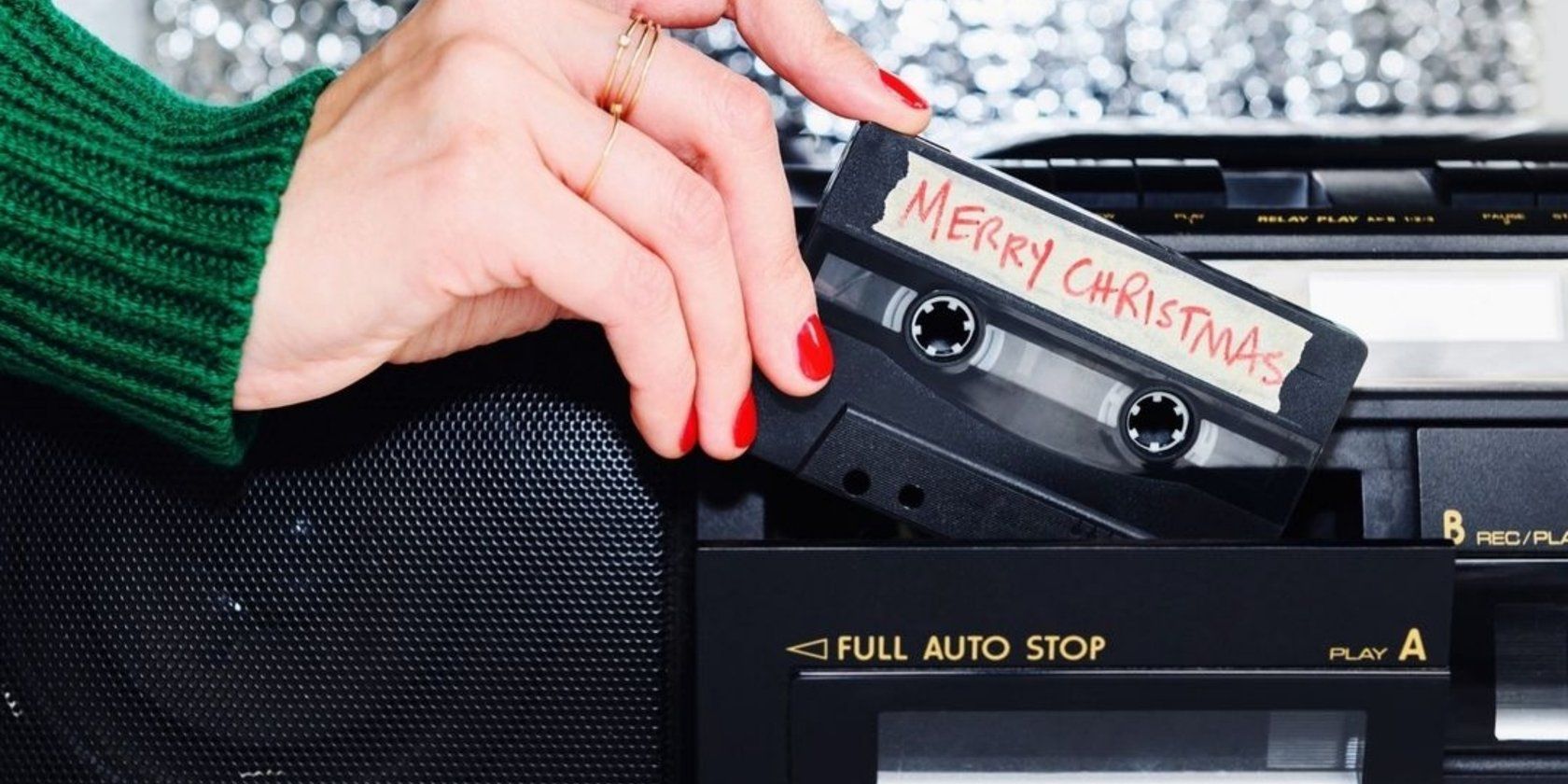 Woman putting Christmas cassette into player