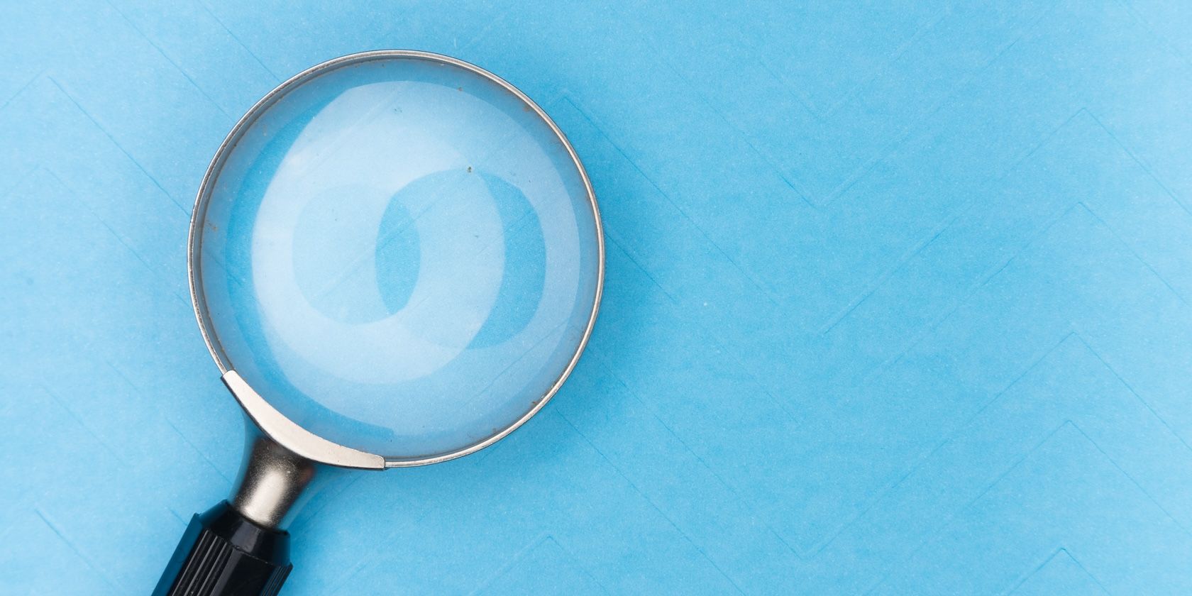 A large magnifying glass on a blue background