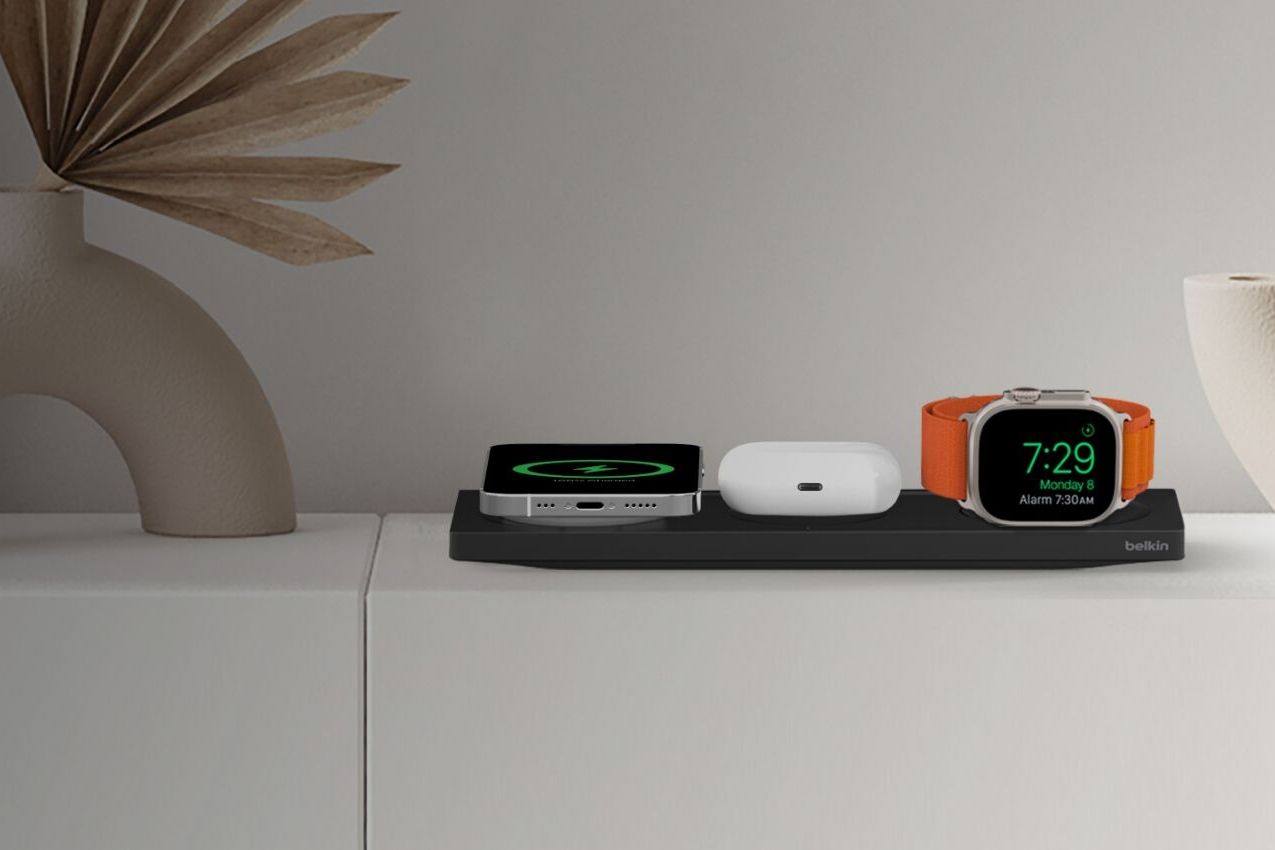 a smart watch, phone, and earbuds charge on a belkin boostcharge pro