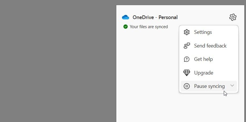 Clicking on the Pause Syncing option in OneDrive