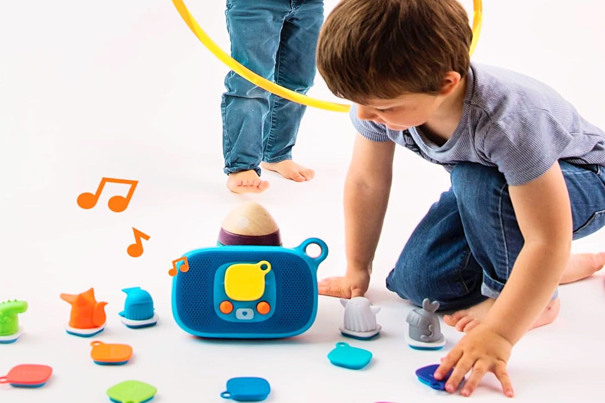 A boy and another child playing and listening to Jooki Music Player for Kids