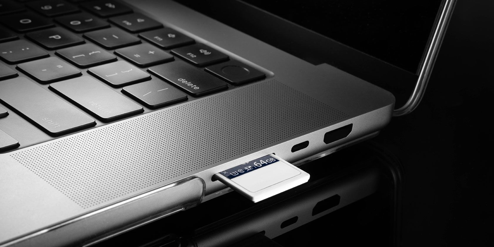 SD card being inserted into laptop slot