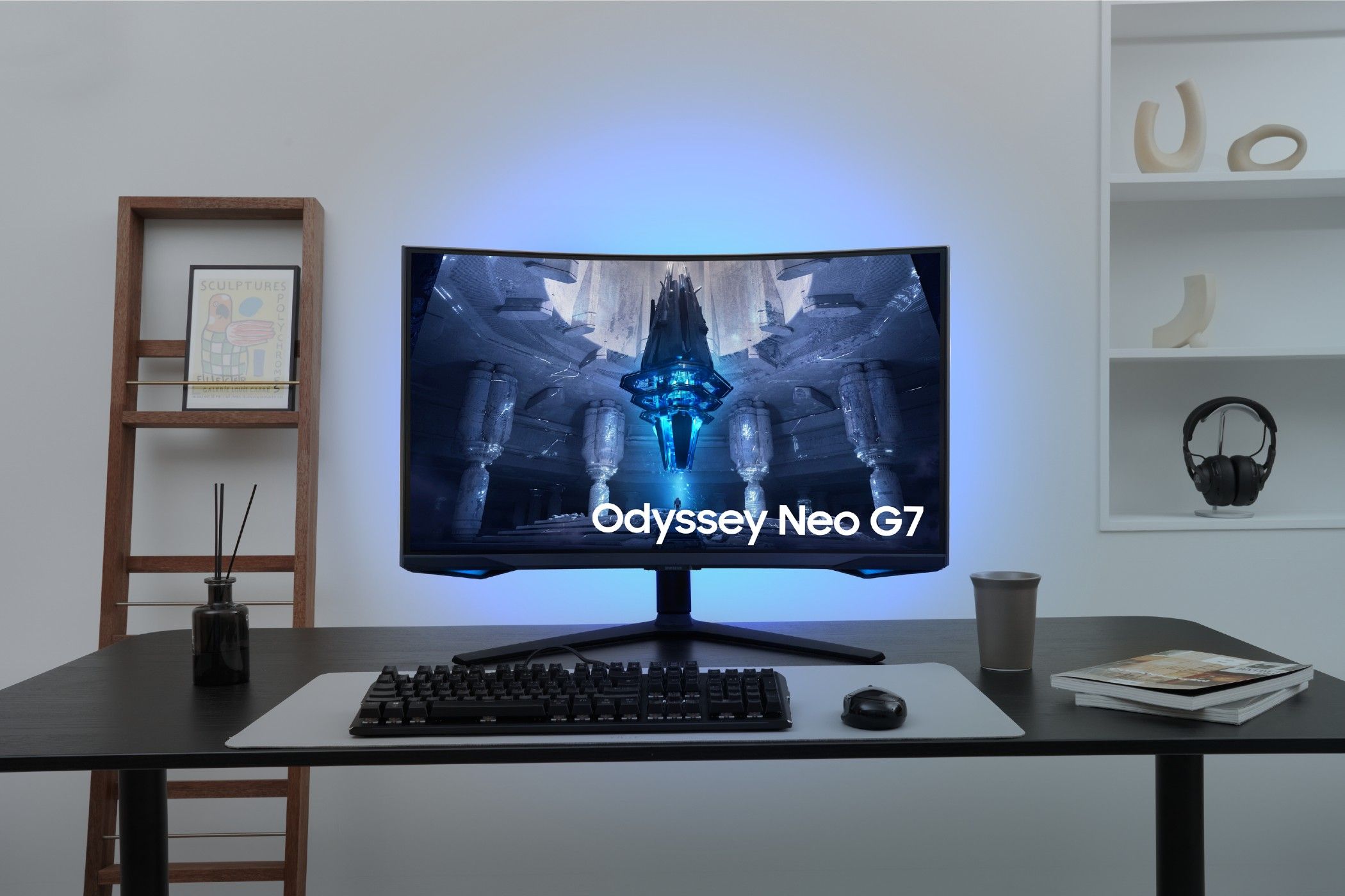 The Odyssey Neo G7 on a desk with a gaming keyboard and mouse.