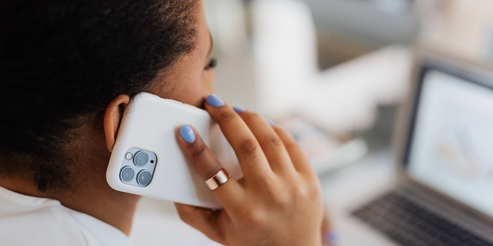 Woman holding iPhone to ear on call