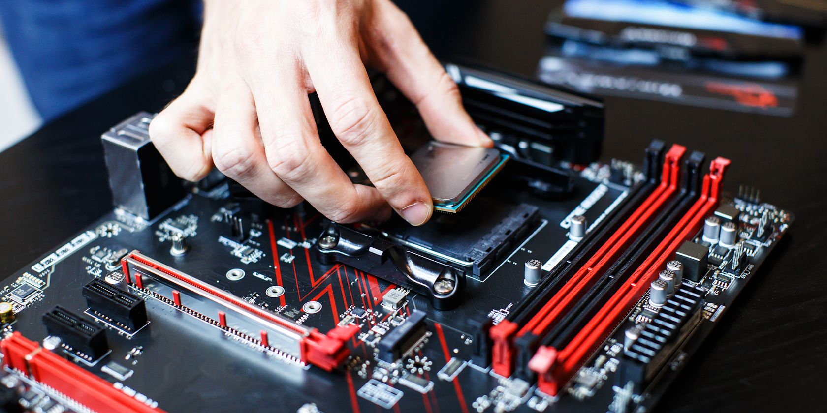 person inserting cpu into cpu slot on motherboard